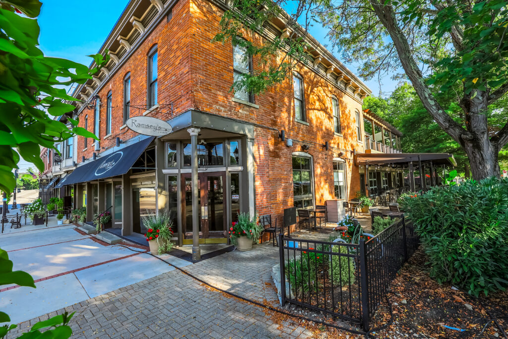 Historic brick restaurant with outdoor patio seating in downtown Loveland, Ohio.